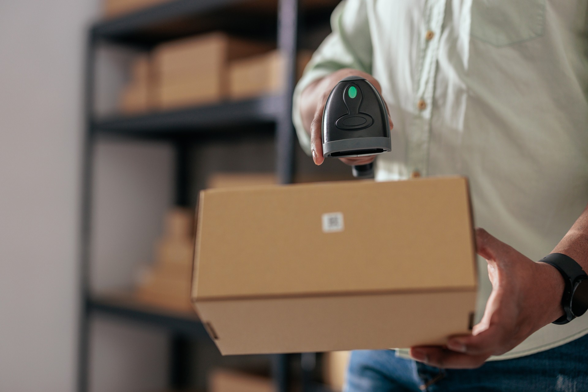 Close-up of package scanning process in warehouse
